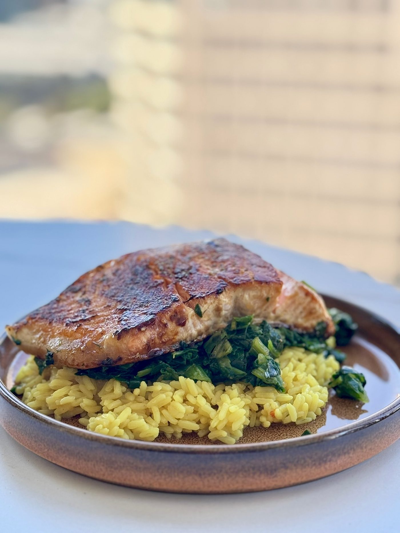Blackened salmon over saffron rice and greens