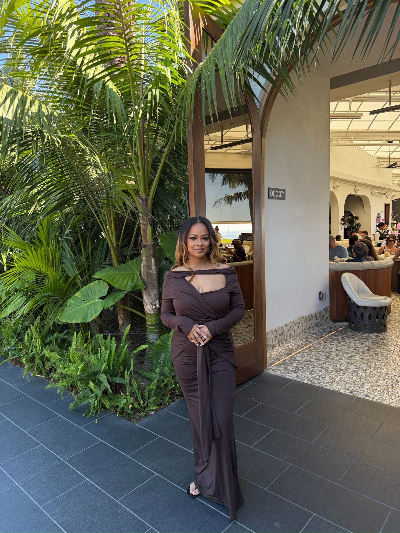 Tasha LaShawn at a lush resort entrance